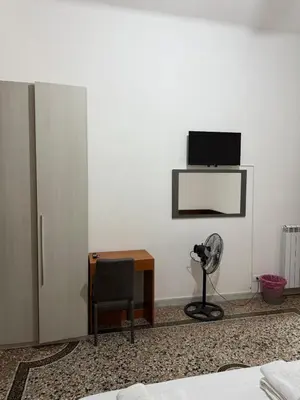 a room with a desk and a tv on a wall at Roma Belvedere Termini in Rome