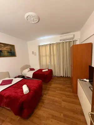 a hotel room with two beds and a television at Two Ducks Hostel in Rome