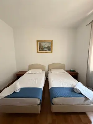 two beds sitting next to each other in a room at Two Ducks Hostel in Rome