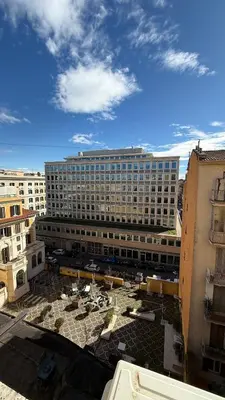 a large building with a parking lot in front of it at Two Ducks Hostel in Rome