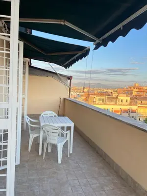 a table and chairs on a balcony with a view at Oasi di pace in Rome