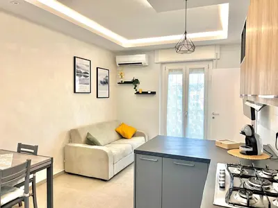 a kitchen and living room with a couch and a table at Oasi di pace in Rome