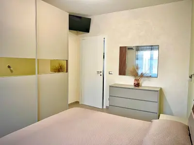 a bedroom with a bed and a dresser and a mirror at Oasi di pace in Rome