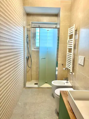 a bathroom with a shower and a toilet and a sink at Oasi di pace in Rome