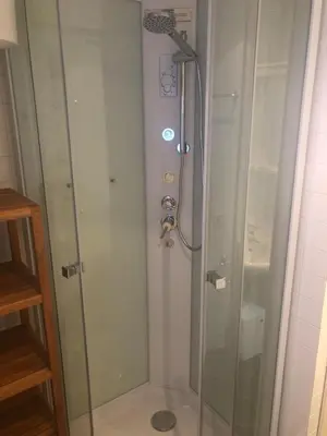 a shower in a bathroom with a glass door at Trastevere Mini-apartment in Rome