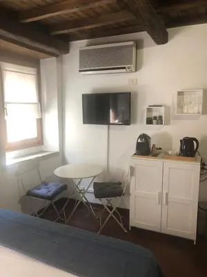 a kitchen with a table and two chairs and a table at Trastevere Mini-apartment in Rome