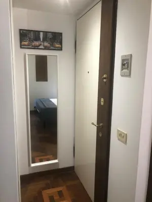 a room with a door and a mirror and a bedroom at Trastevere Mini-apartment in Rome