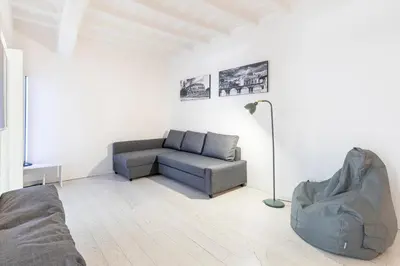 a living room with a couch and a chair at Maison Parlamento - Roma centro in Rome