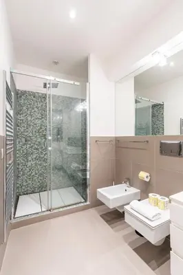 a bathroom with a shower and a toilet and a sink at Maison Parlamento - Roma centro in Rome