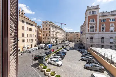 a city street with cars parked in a parking lot at Maison Parlamento - Roma centro in Rome