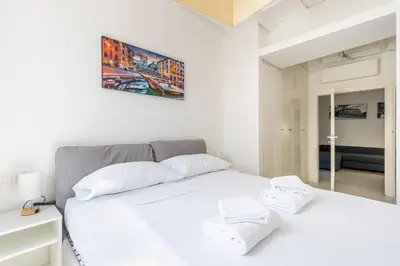 a bedroom with a white bed and a mirror at Maison Parlamento - Roma centro in Rome