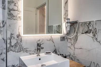 a bathroom with a sink and a mirror at The Spotlight Boutique Hotel in Rome