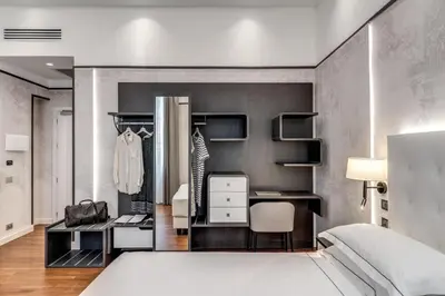 a bedroom with a bed and a desk at The Spotlight Boutique Hotel in Rome