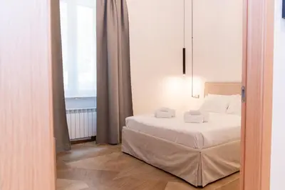 a bedroom with a bed and a large window at Angelico living Rome in Rome