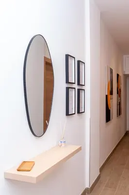 a mirror on a wall with a shelf at Angelico living Rome in Rome