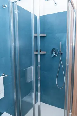 a shower with a glass door in a bathroom at Angelico living Rome in Rome