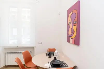 a dining room with a table and orange chairs at Angelico living Rome in Rome