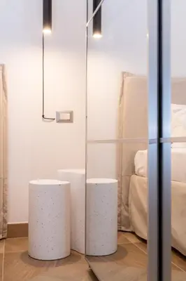 two white stools in a room with a glass wall at Angelico living Rome in Rome