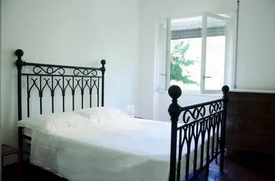 a black bed in a white bedroom with a window at Dolcevita suite in Rome