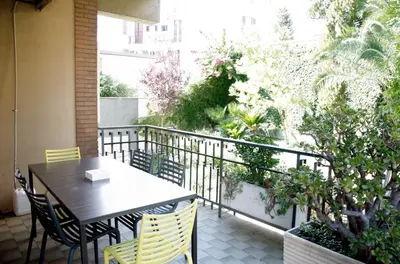 a patio with a table and chairs and a balcony at Dolcevita suite in Rome