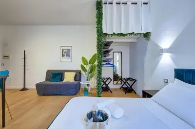 a living room with a bed and a couch at Cinema Design Home San Giovanni in Rome