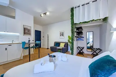 a white apartment with a kitchen and a living room at Cinema Design Home San Giovanni in Rome