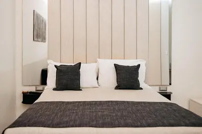 a bedroom with a bed with black pillows at Room 230 Roma Luxury Suites in Rome