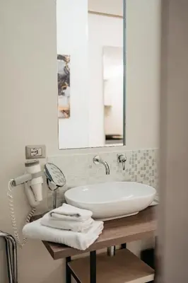 a bathroom with a sink and a mirror at Room 230 Roma Luxury Suites in Rome