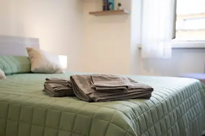 a pile of towels sitting on top of a bed at Annmarie House, Vaticano - Cipro in Rome