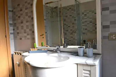 a bathroom with two sinks and a shower at Annmarie House, Vaticano - Cipro in Rome