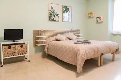 a bedroom with a bed and a flat screen tv at Annmarie House, Vaticano - Cipro in Rome
