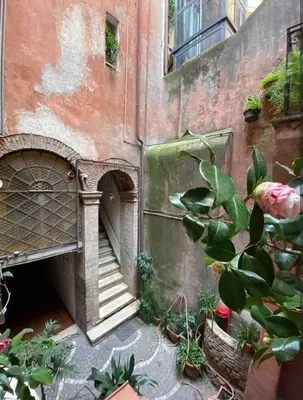 an old building with a staircase and some plants at Arco acetari-Il medio evo nel cuore di roma in Rome