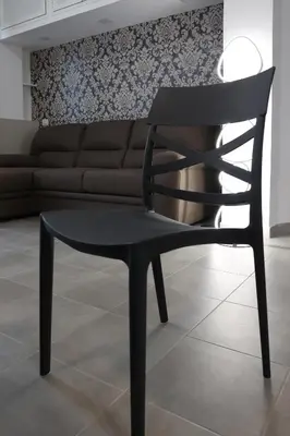 a black chair in a living room with a couch at Sweet Home Fleming in Rome