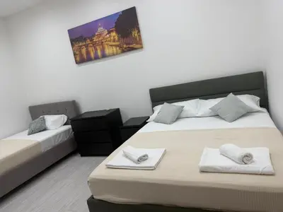 a bedroom with two beds with towels on them at Gazi House in Rome