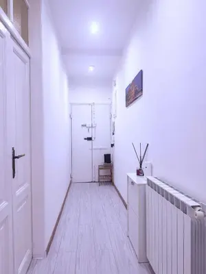 a hallway with white walls and a white door at Gazi House in Rome