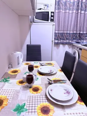 a table with a table cloth with sunflowers on it at Gazi House in Rome