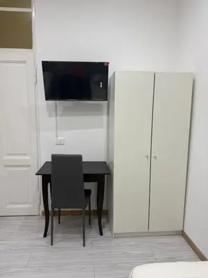 a dining room with a black table and a cabinet at Gazi House in Rome