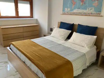 a bedroom with a large bed with blue and white pillows at Domus4U in Rome