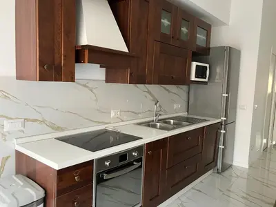 a kitchen with a sink and a refrigerator at Domus4U in Rome