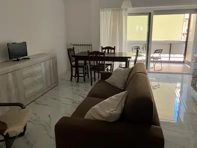 a living room with a couch and a dining room at Domus4U in Rome