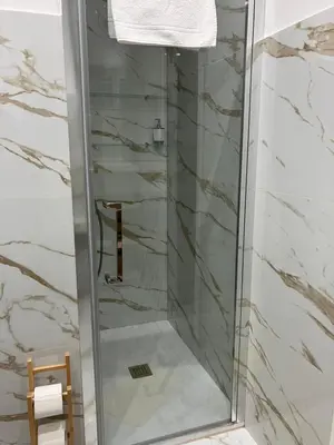 a shower with a glass door in a bathroom at Domus4U in Rome