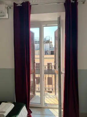 a room with a window with a view of a building at TERMINI ROMA CENTRo in Rome