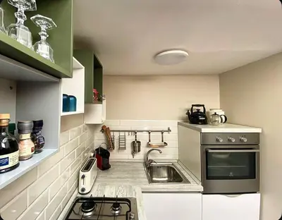 a small kitchen with a sink and a stove at Residenza Merulana in Rome