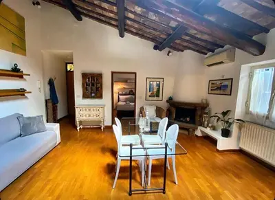 a living room with a table and a couch at Residenza Merulana in Rome