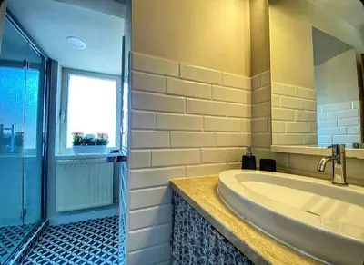 a bathroom with a large tub and a window at Residenza Merulana in Rome