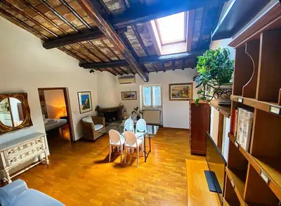a living room with a table and chairs at Residenza Merulana in Rome
