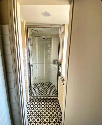 a bathroom with a shower with a glass door at Residenza Merulana in Rome