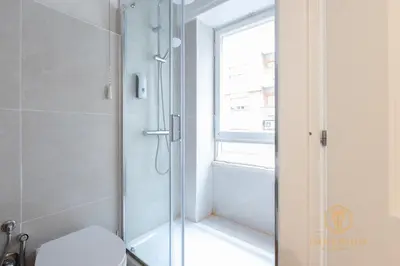 a bathroom with a shower with a toilet and a window at Imperium Garbatella Guesthouse - 2 bedrooms with private bathroom, Terrace, 800mt to metro in Rome