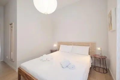 a bedroom with a white bed with towels on it at Pop Domus Guest House o Affittacamere in Rome
