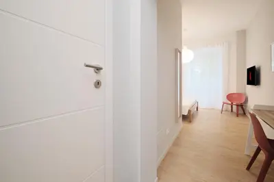 a room with a door and a dining room with a table at Pop Domus Guest House o Affittacamere in Rome